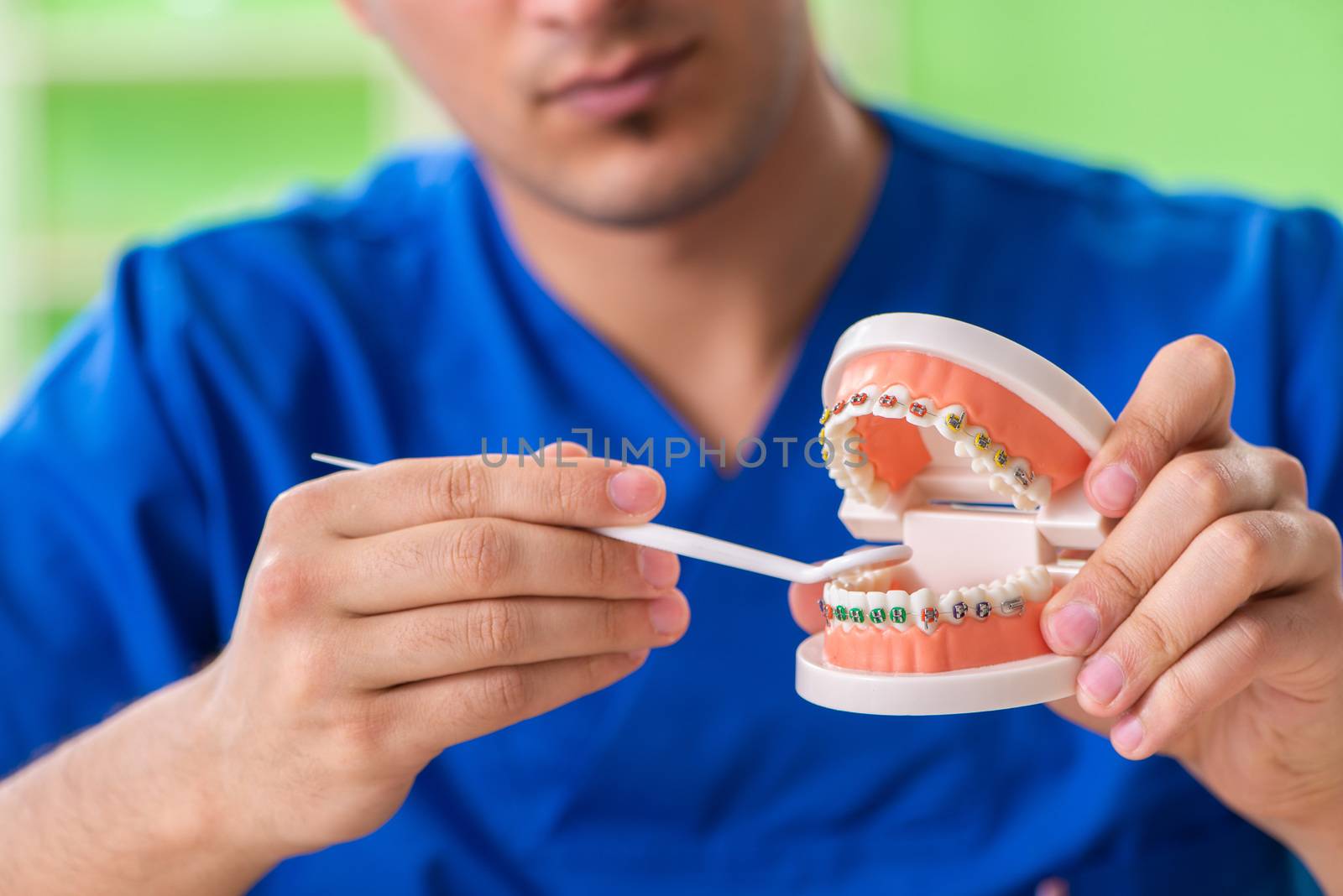 Man dentist working on new teeth implant  by Elnur