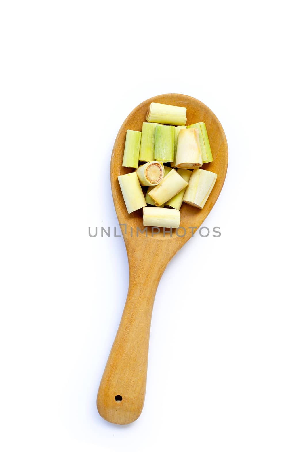 Lemongrass slices on wooden spoon on white  by Bowonpat
