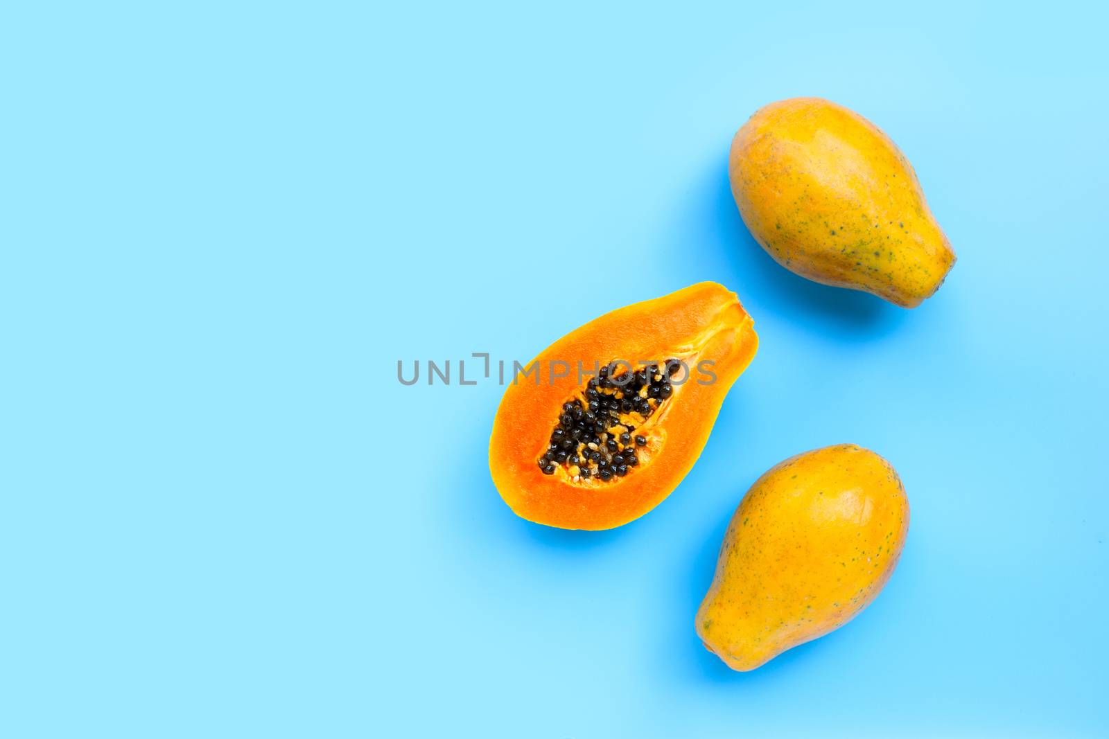 Papaya fruit on blue background. Top view