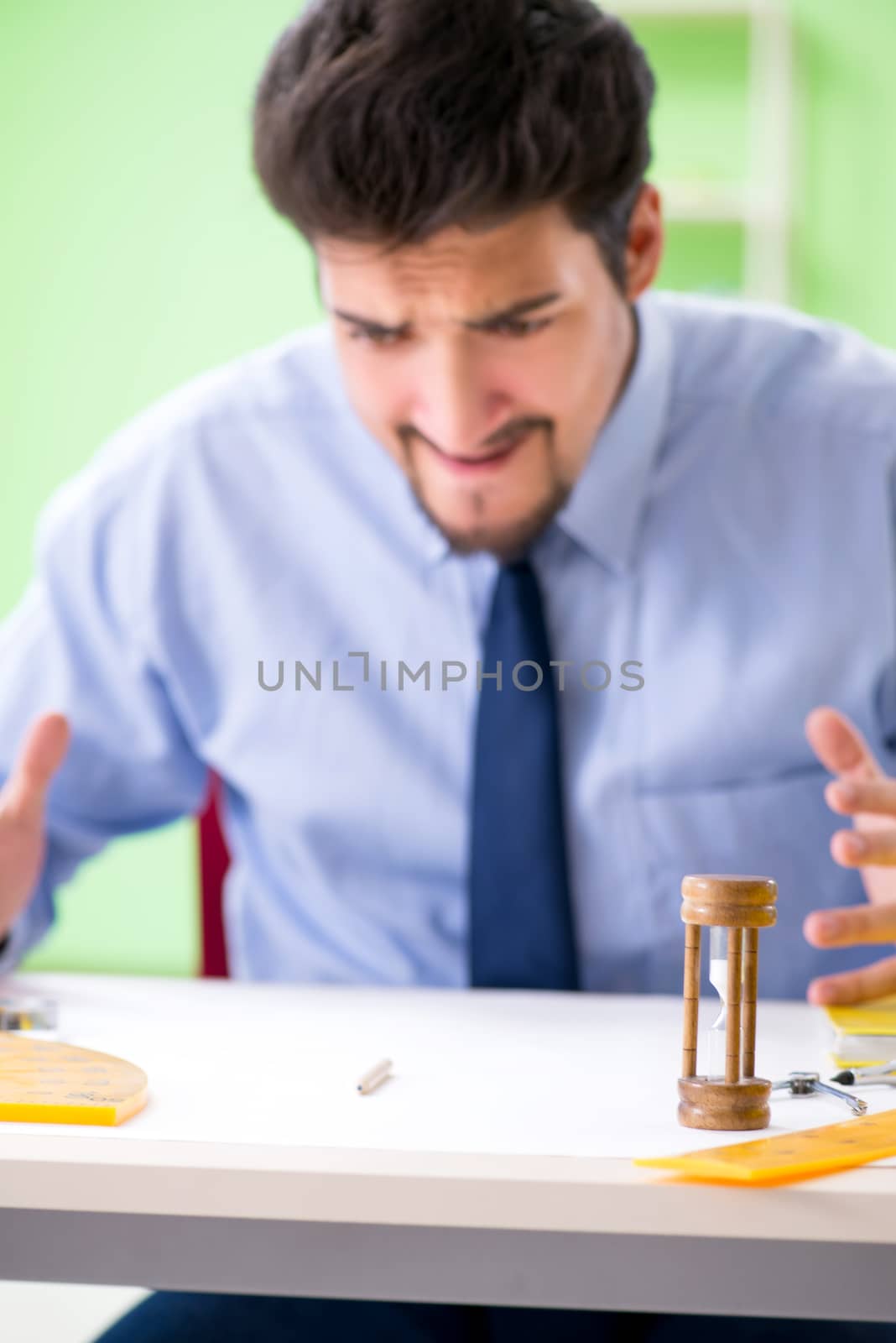 Young male architect working at the project