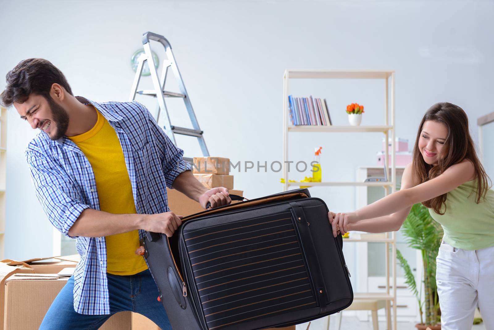 Young family with suitcase in relocation concept