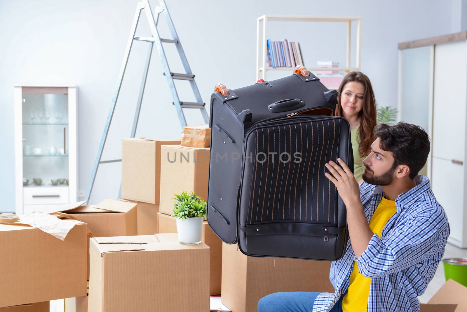 Young family with suitcase in relocation concept