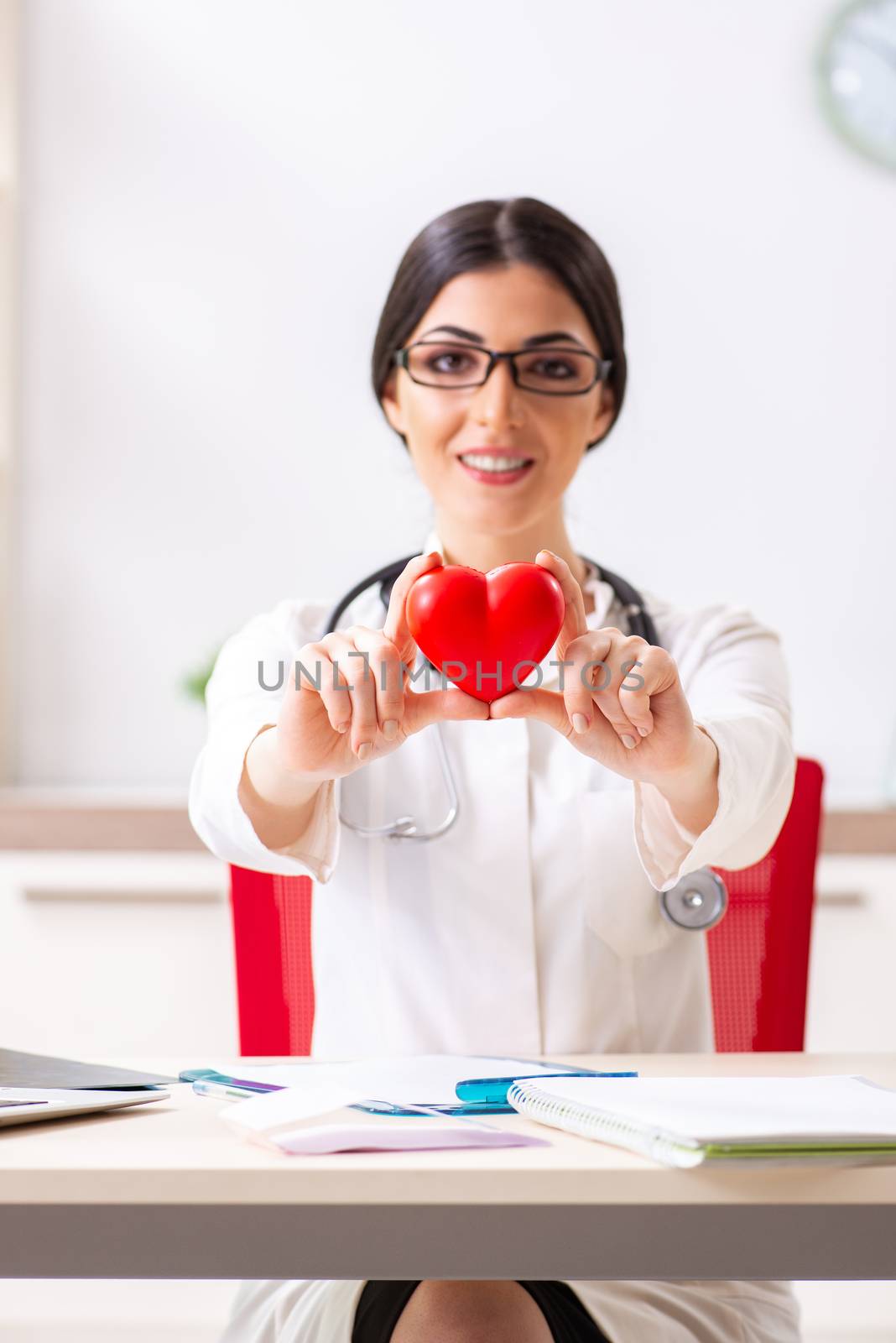 Young doctor in heart care concept