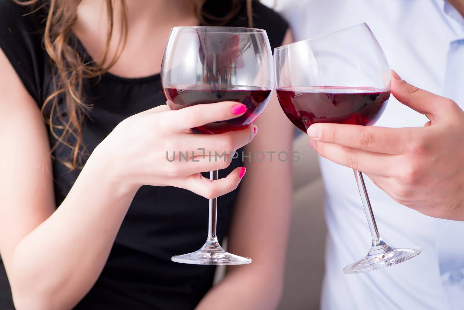 Young pair drinking wine in romantic concept