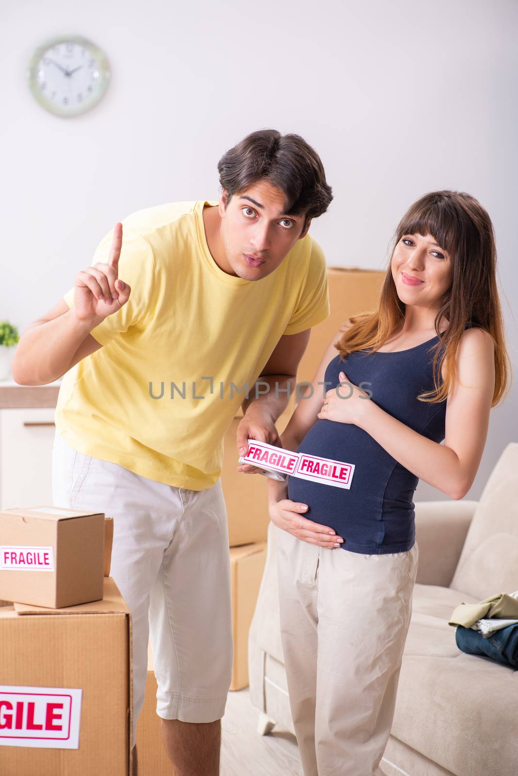 Young couple moving to new flat with fragile things