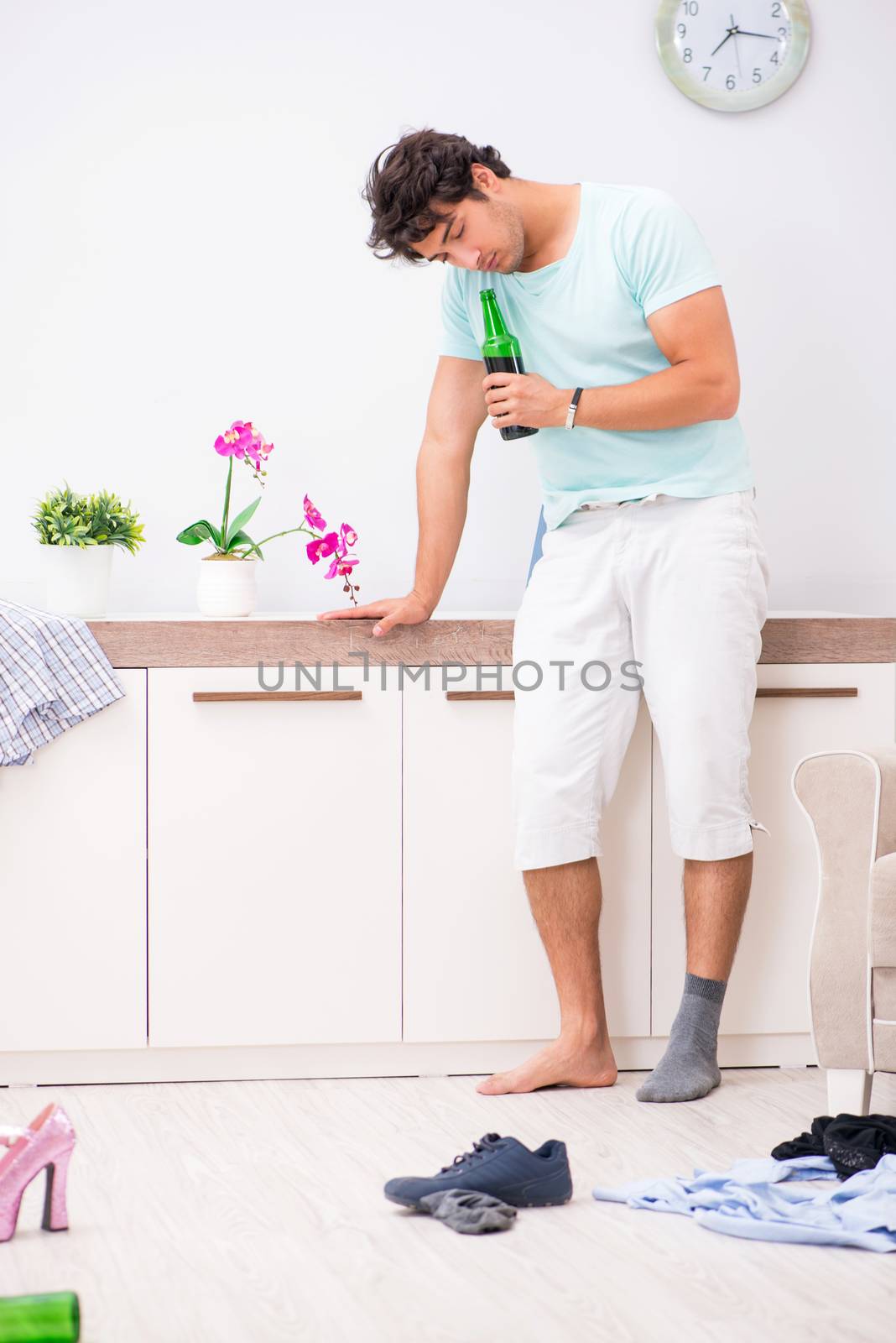 Young drunk handsome man after party at home 