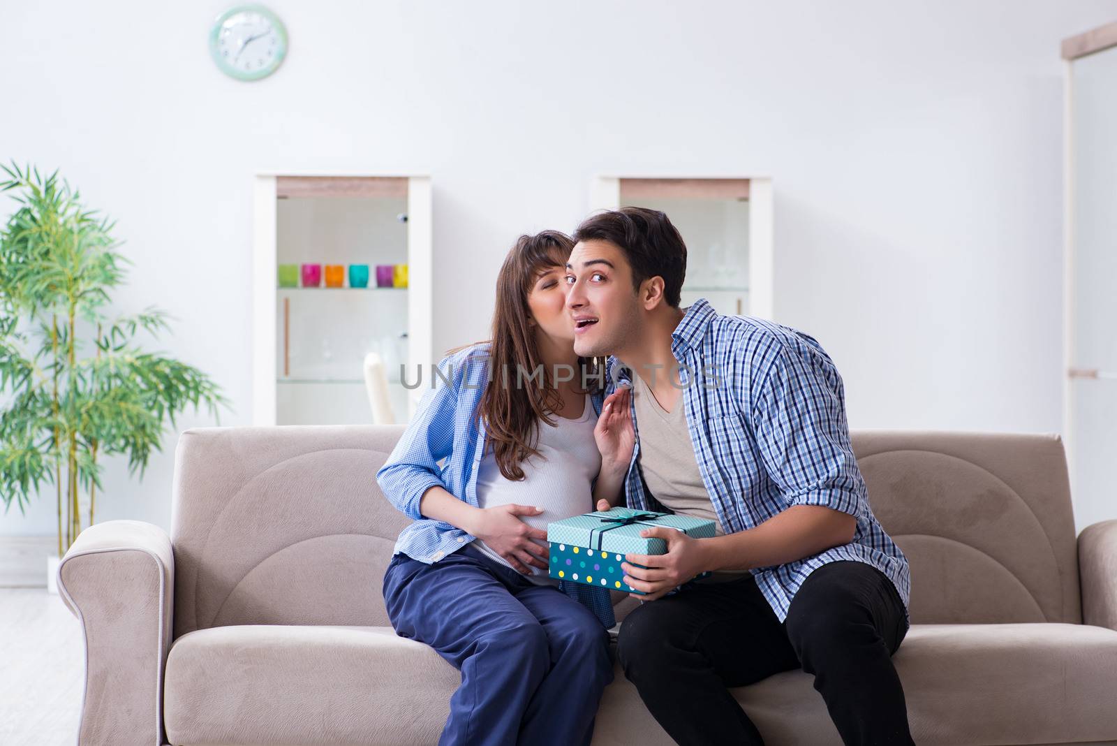 Happy family celebrating pregnancy at home