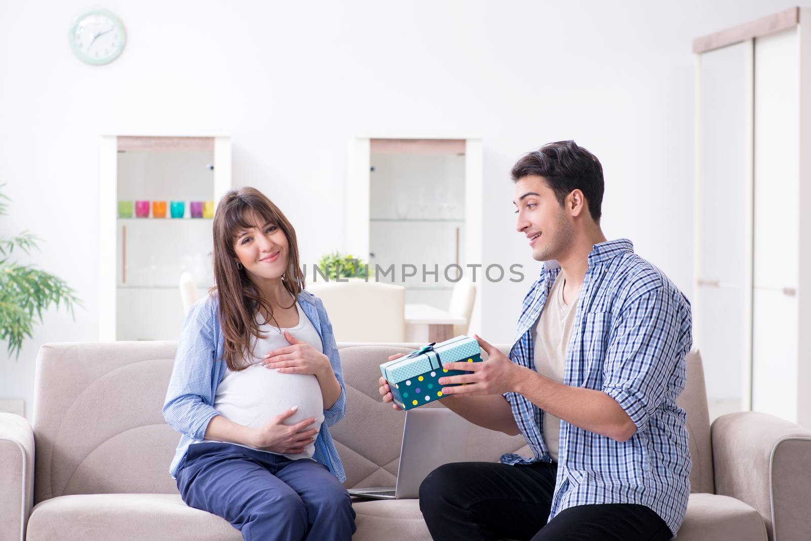 Happy family celebrating pregnancy at home