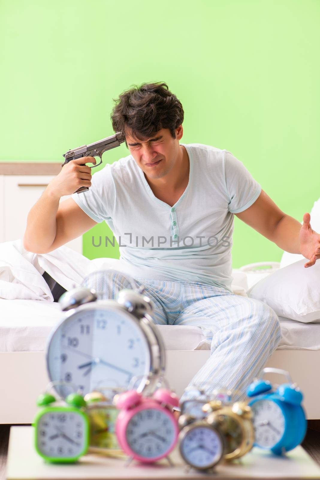 Young man having trouble waking up in early morning