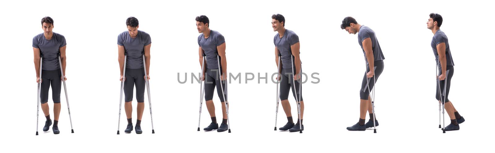 Young patient athlete sportsman suffering an injury trauma with crutches isolated on white
