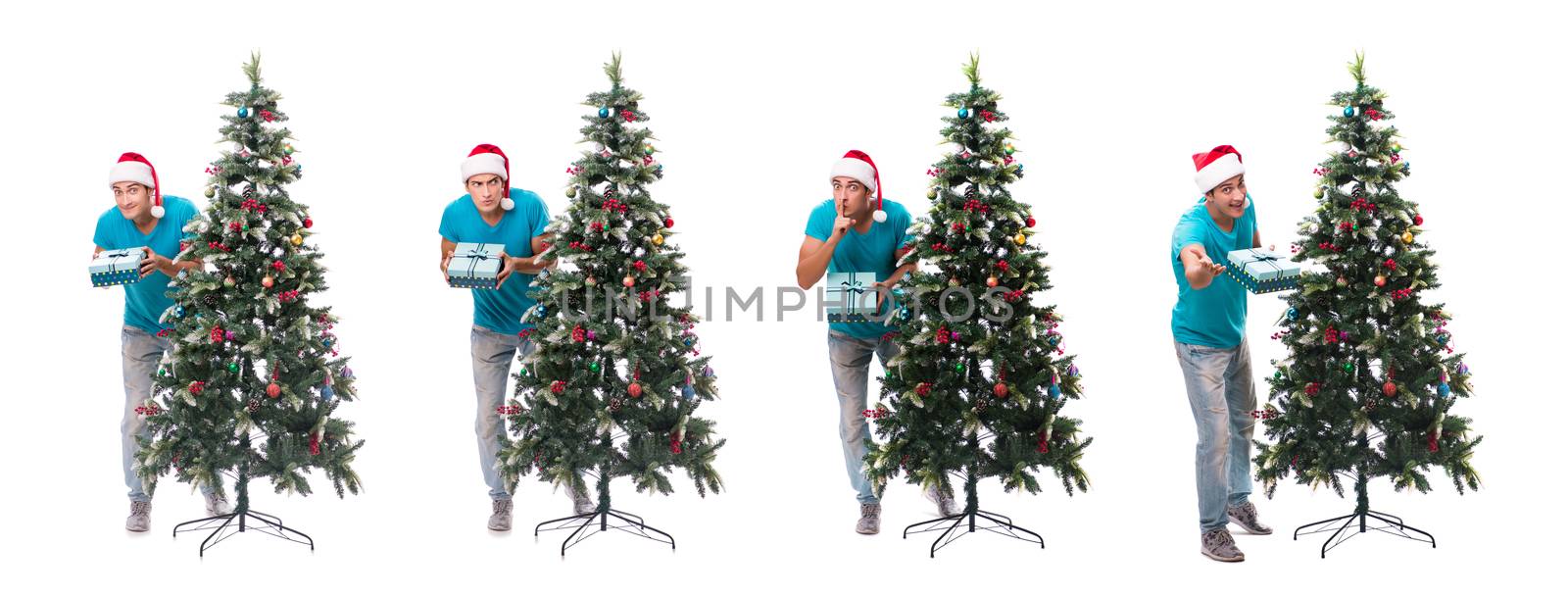 Young man decorating christmas tree isolated on white by Elnur