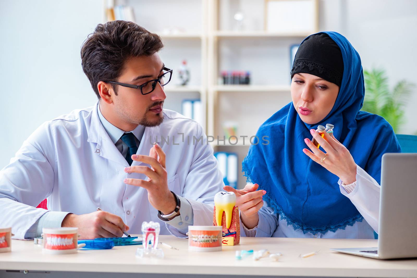 Dentist doctor and assistant working on new tooth implant