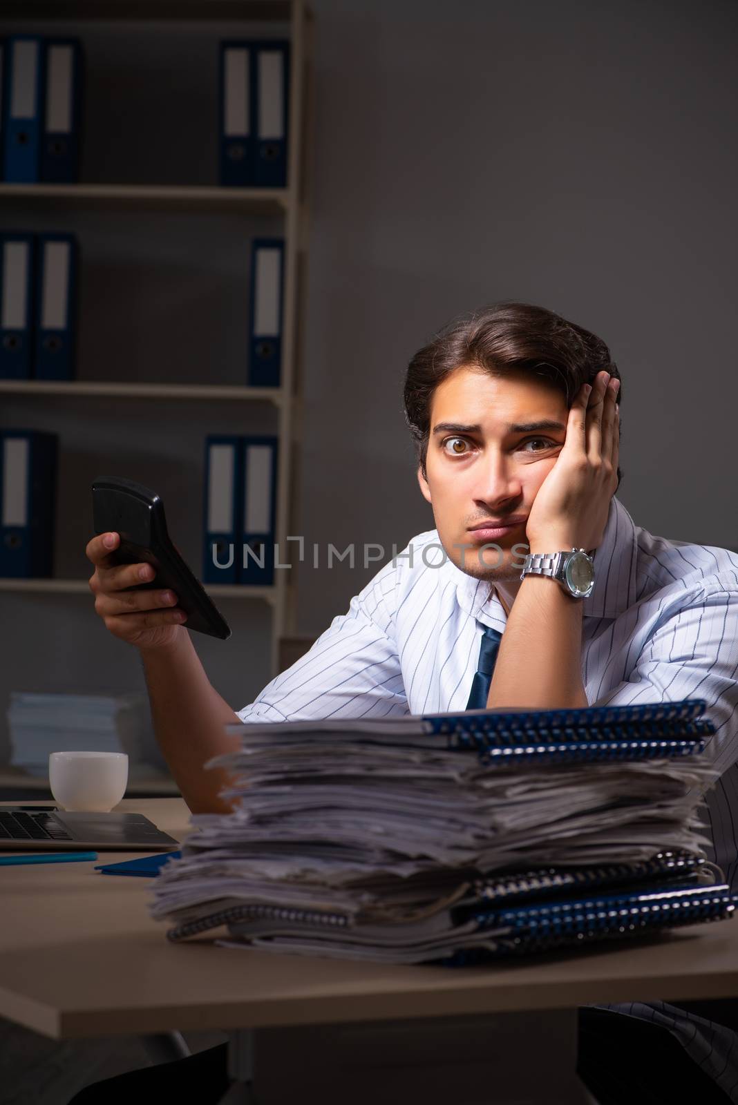 Young financial manager working late at night in office 
