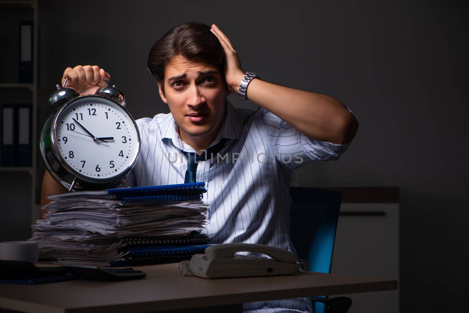 Young financial manager working late at night in office 