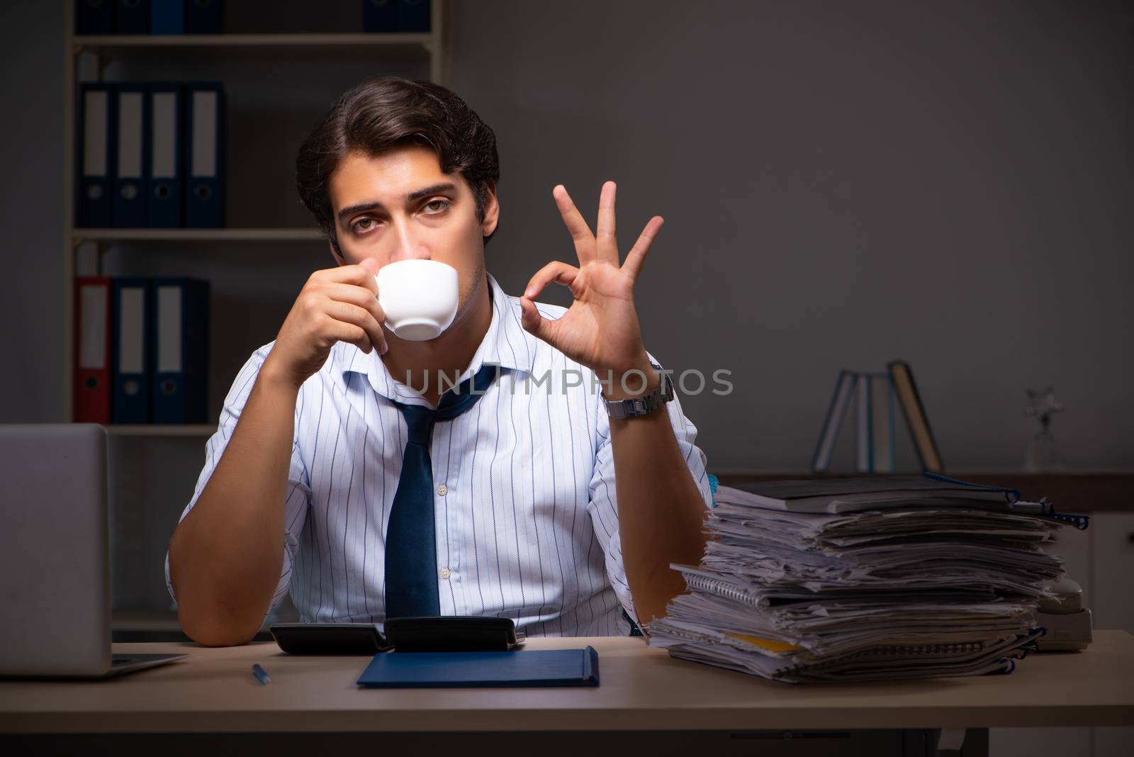 Young financial manager working late at night in office 