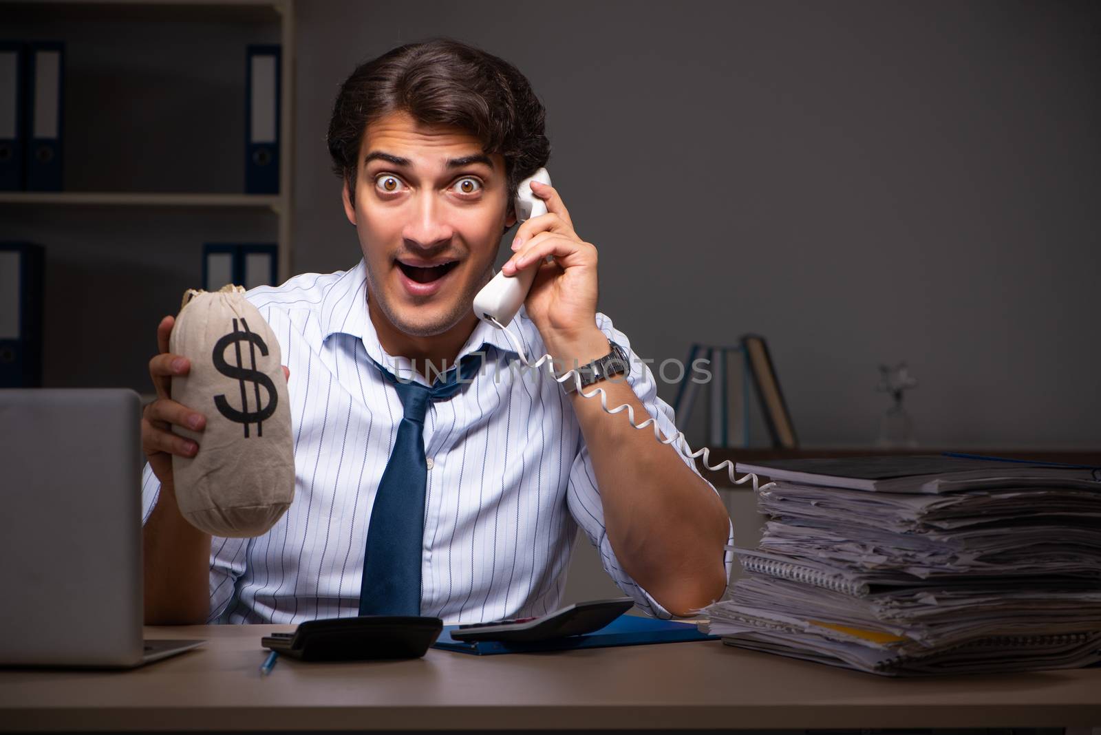 Young financial manager working late at night in office 