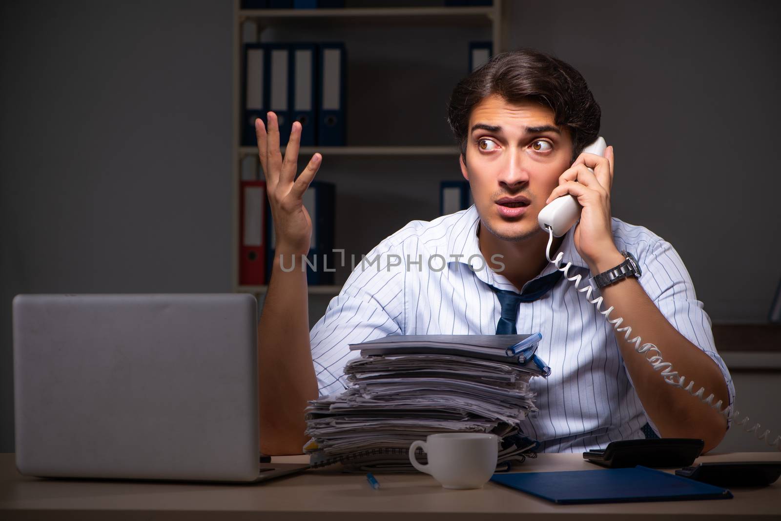Young financial manager working late at night in office 