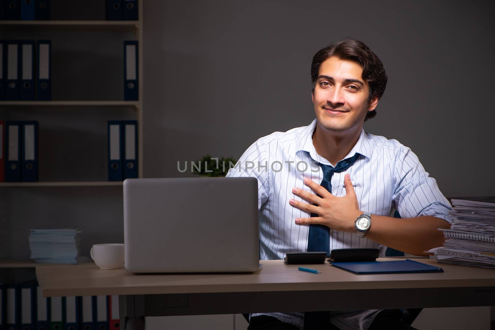 Young financial manager working late at night in office 