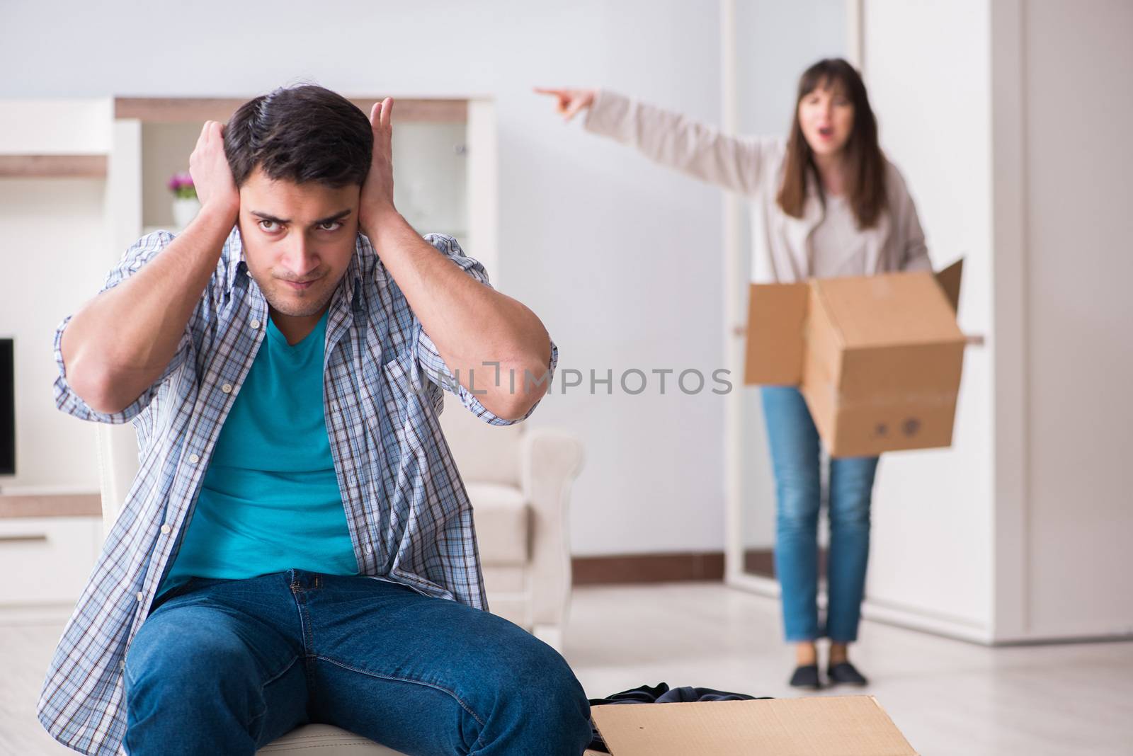 Woman evicting man from house during family conflict