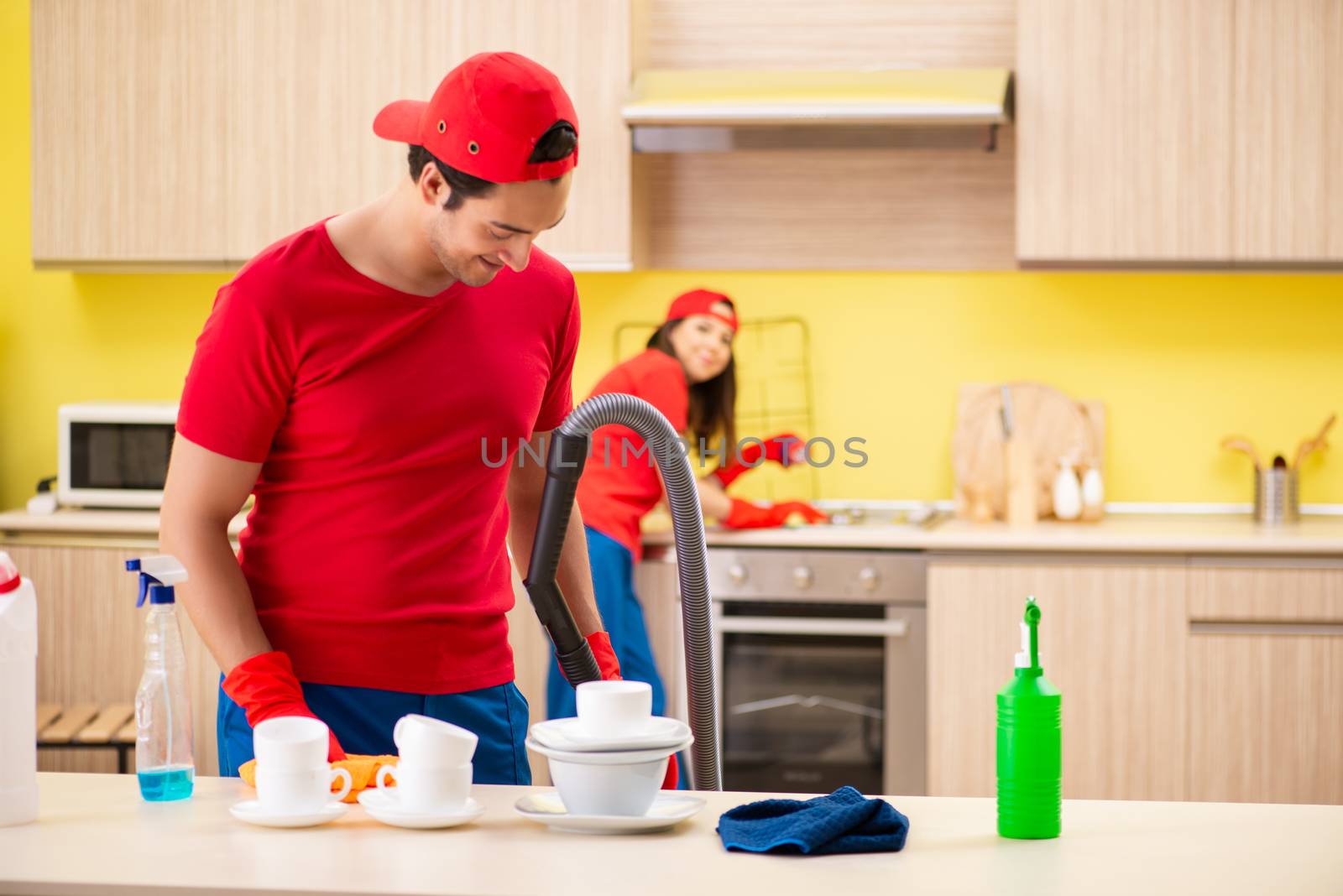Cleaning professional contractors working at kitchen