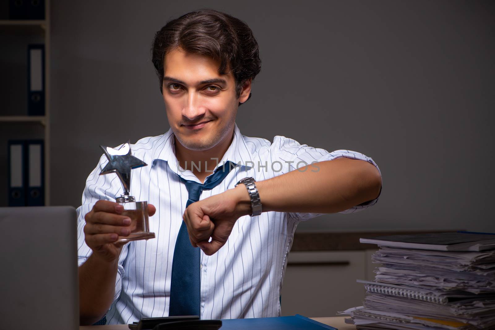 Young financial manager working late at night in office 