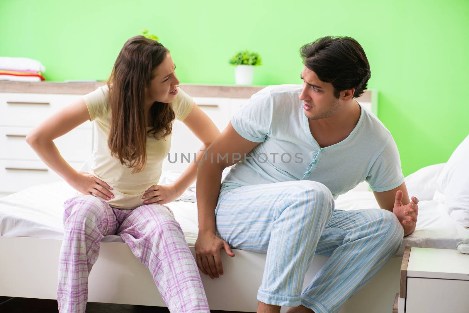 Woman and man in the bedroom during conflict
