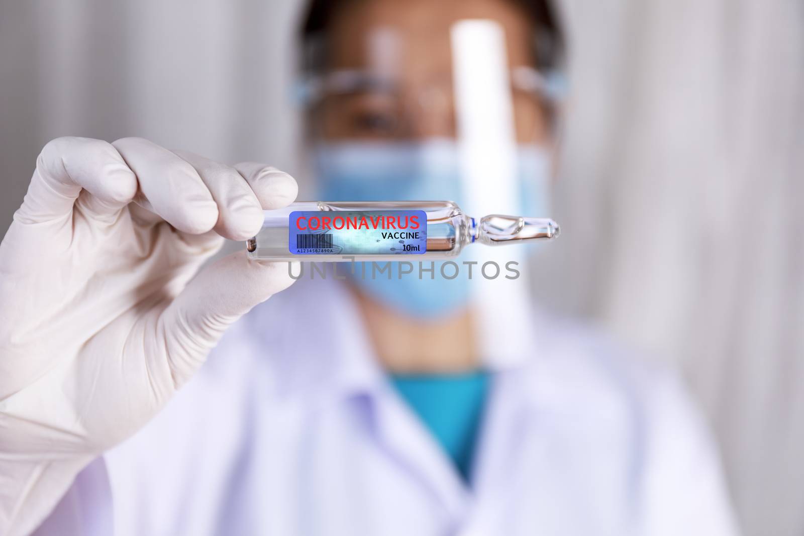 Covid-19 coronavirus vaccine. Close up hands of scientist show Covid-19 vaccine in glass vial. Hands of doctor wear latex glove holding Covid-19 vaccine in glass vial. Healthcare and medical concept.