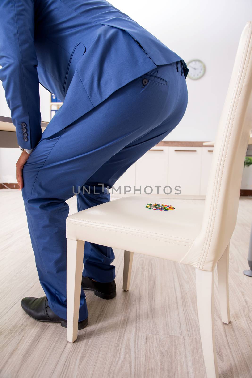 Office prank with sharp thumbtacks on chair