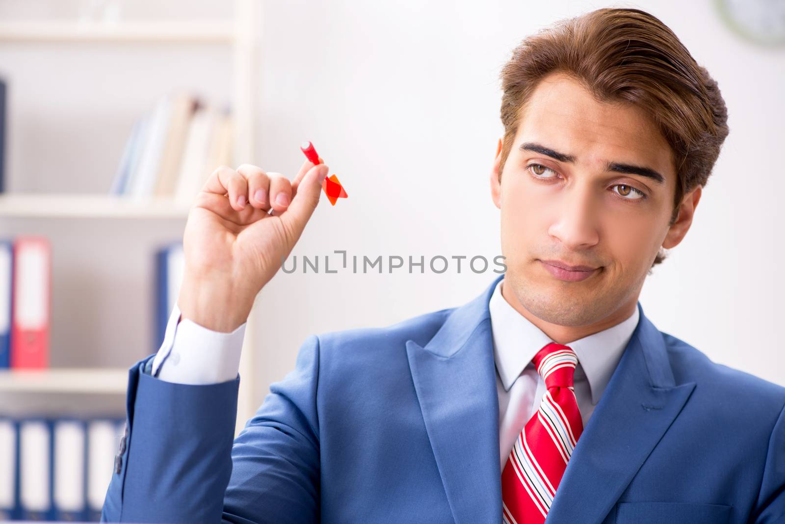Businessman throwing dart in business concept