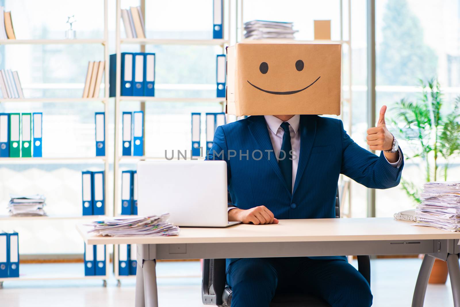 Happy man with box instead of his head