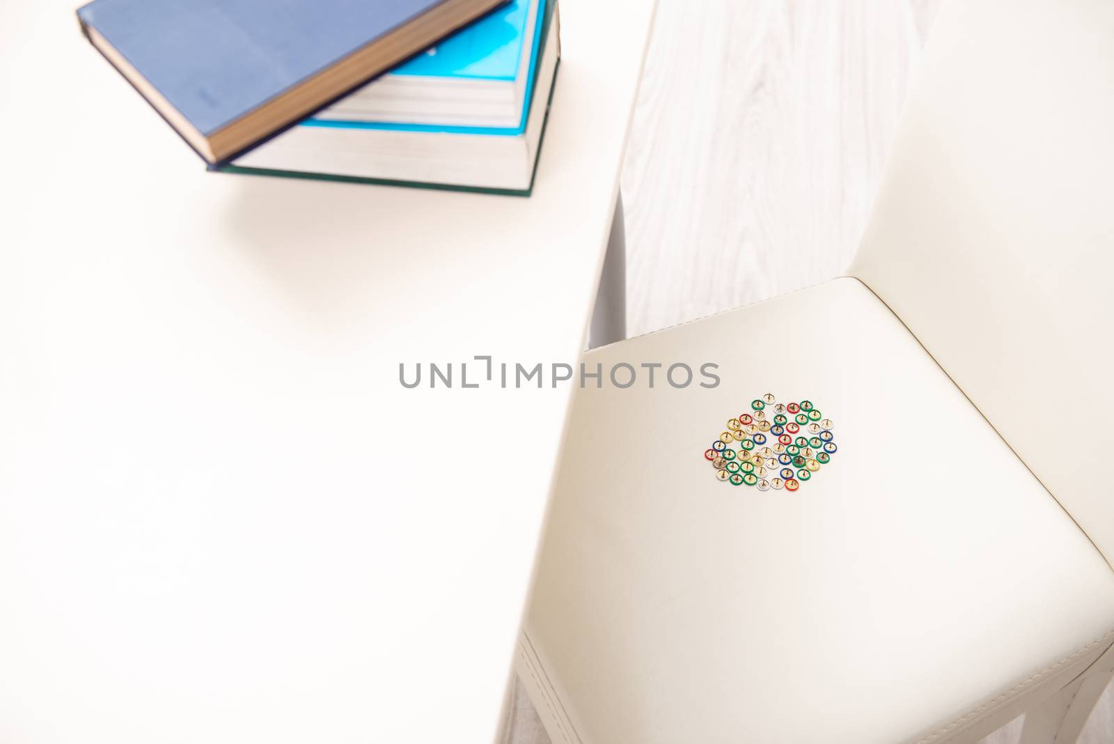 Office prank with sharp thumbtacks on chair
