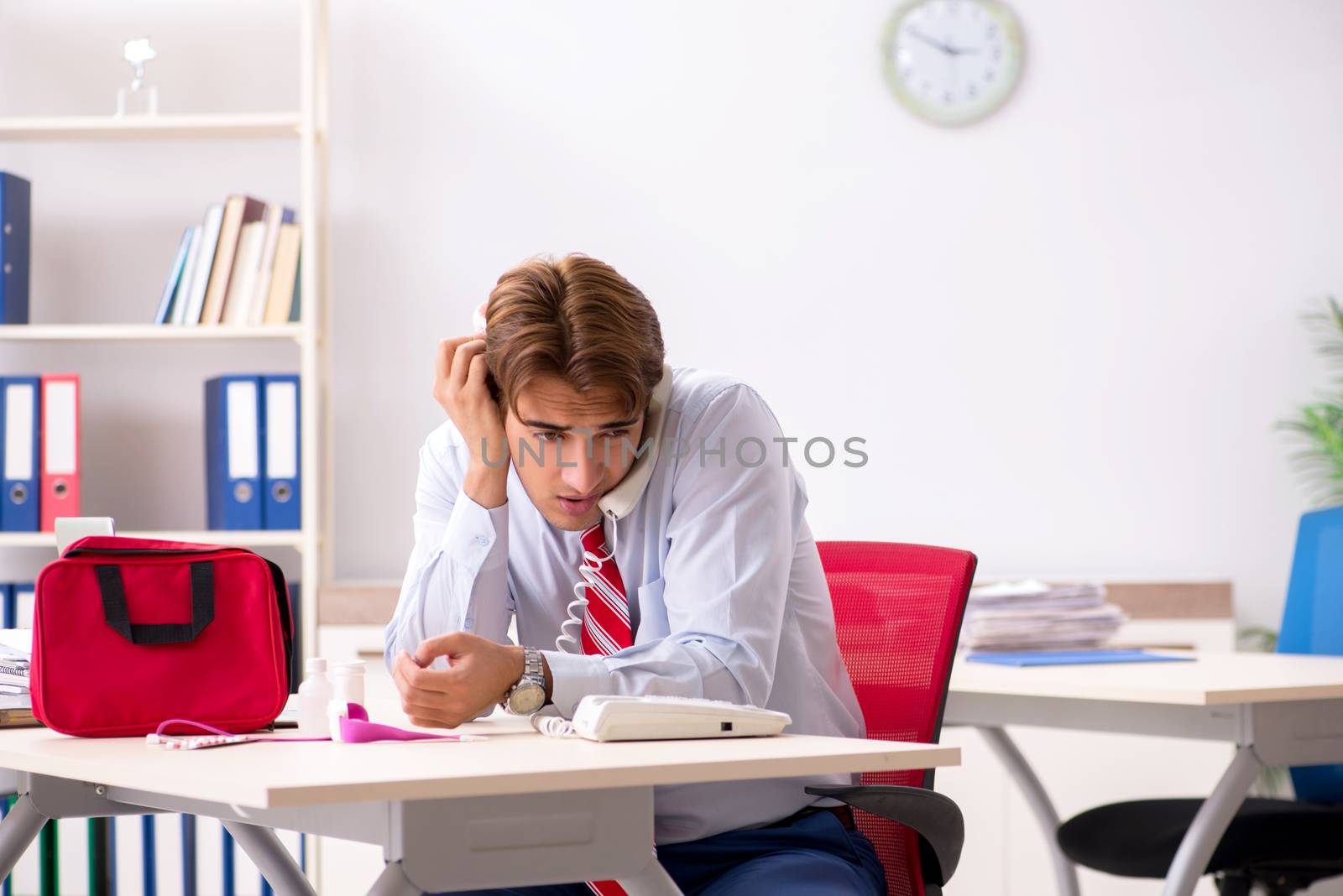 Man with first aid kit in the office