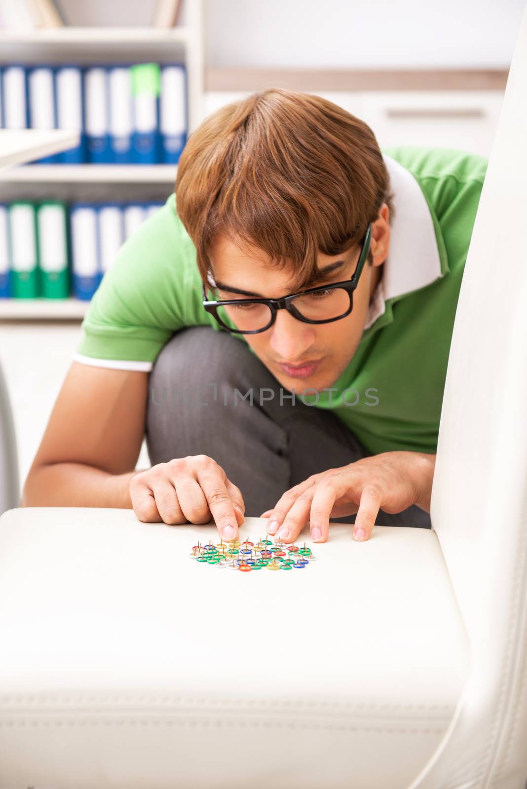 Office prank with sharp thumbtacks on chair