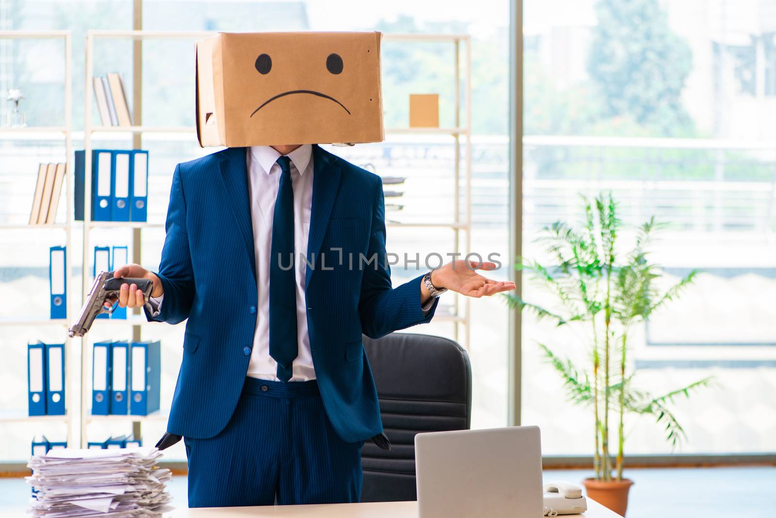 Unhappy man with box instead of his head 