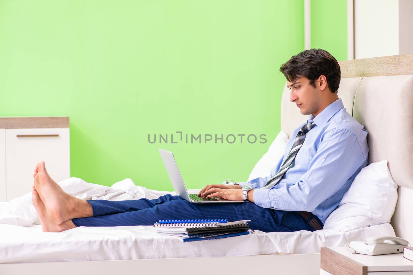 Businessman working overtime in hotel room