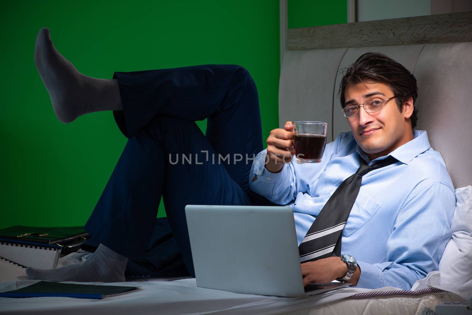Young businessman under stress in the bedroom at night 