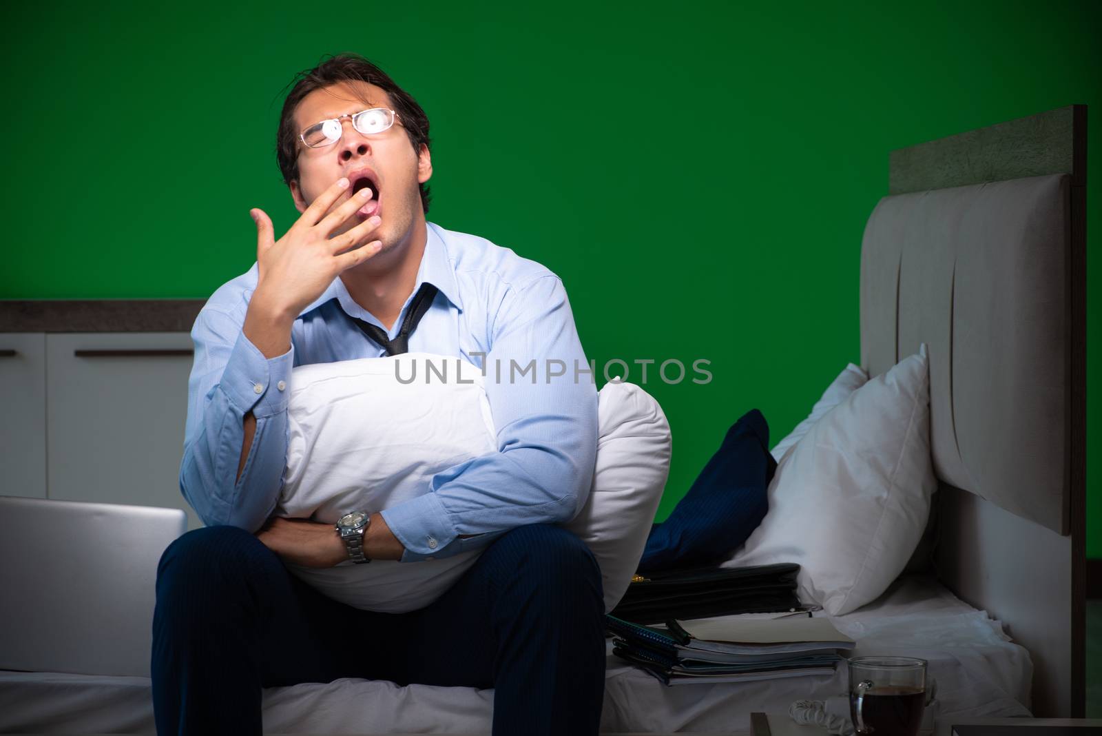 Young businessman under stress in the bedroom at night 