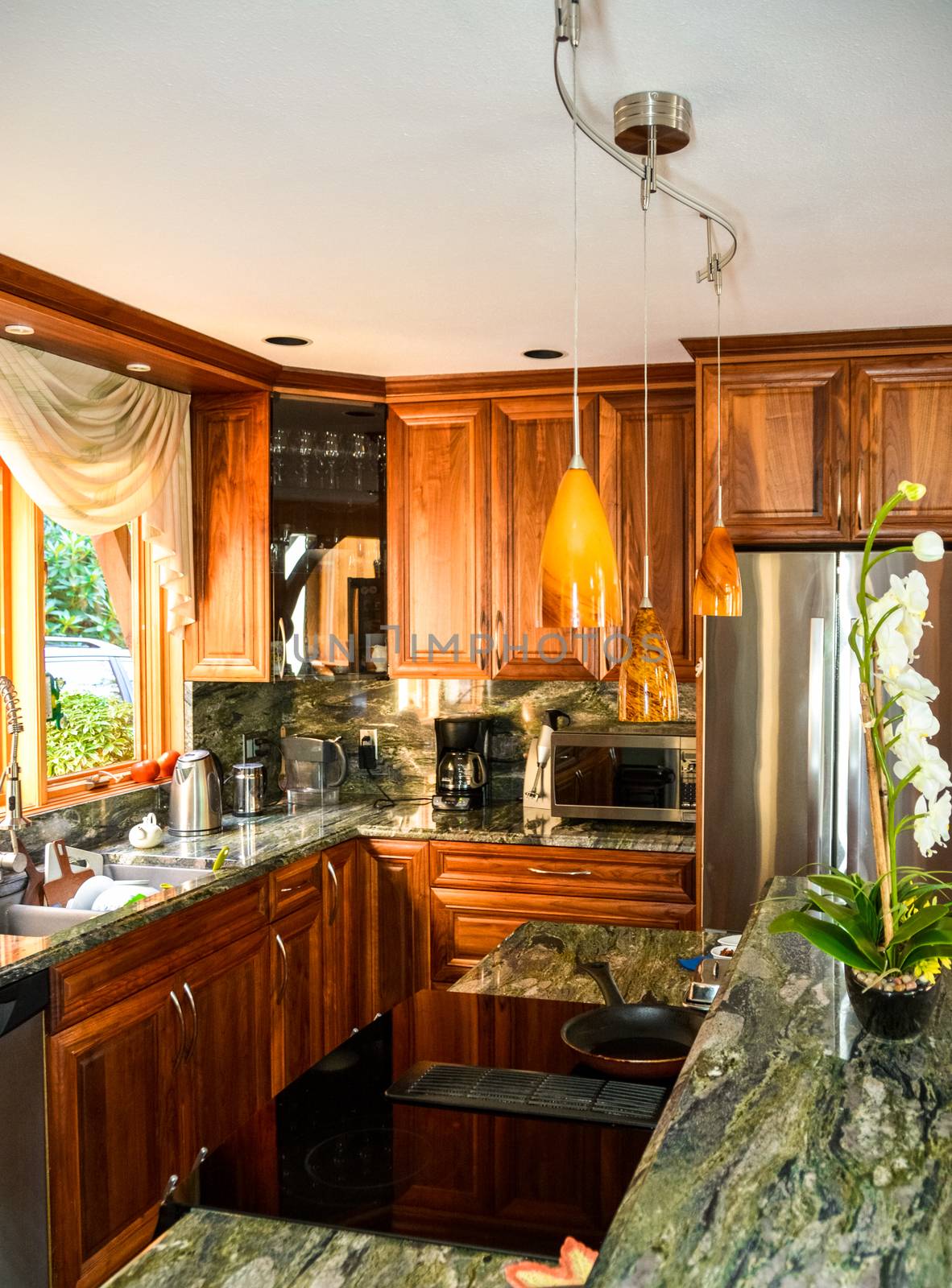 Stylish kitchen wooden interior with ceramic stove on island table