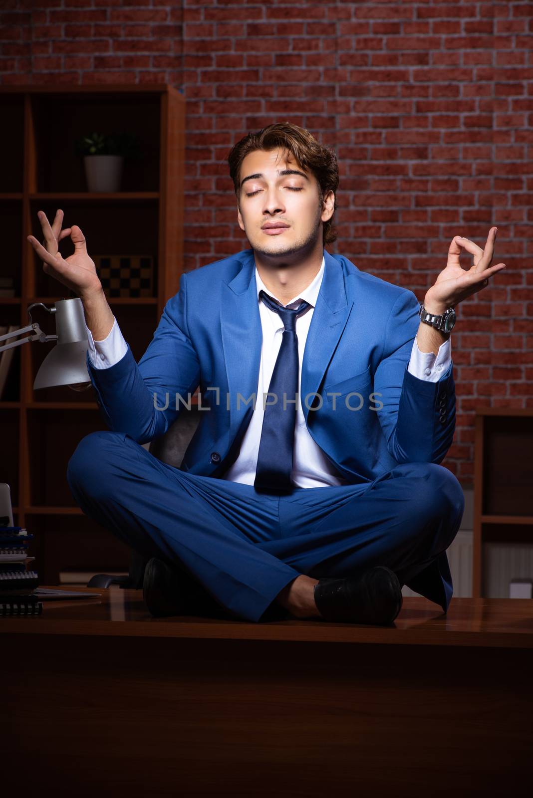 Young businessman working in the office at night 