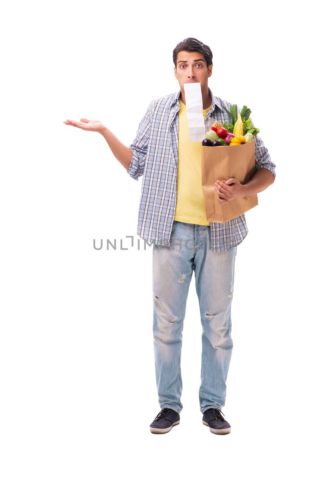Young man with his grocery shopping on white