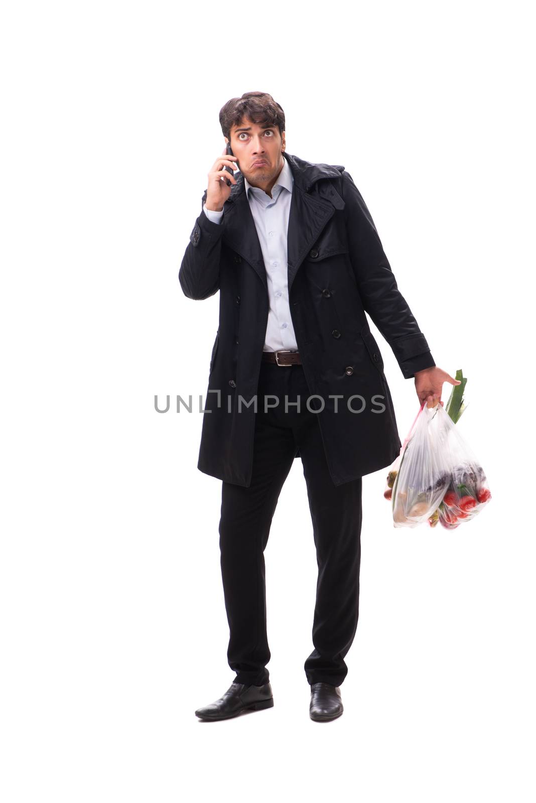 Young handsome man with vegatables in shopping concept 