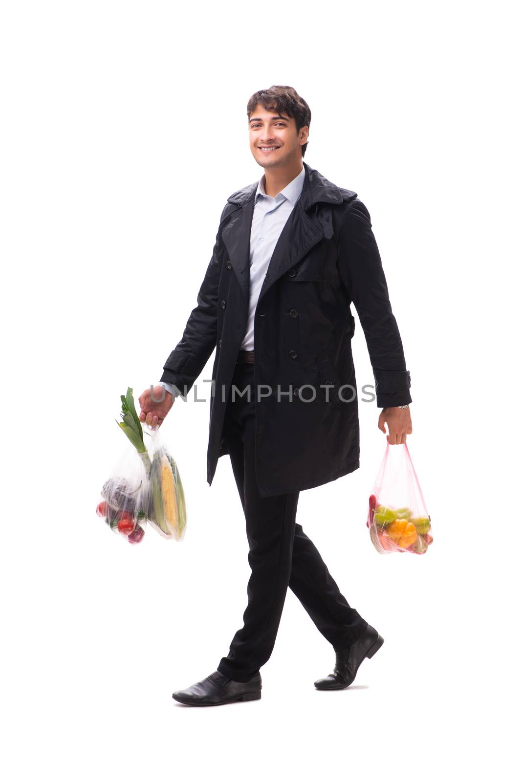 Young handsome man with vegatables in shopping concept 