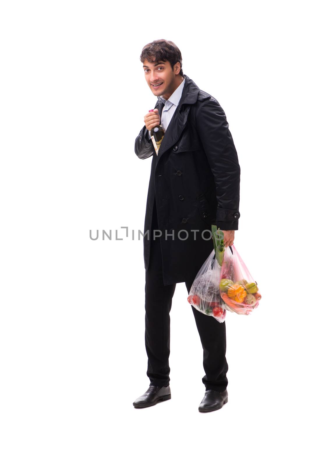 Young handsome man with vegatables in shopping concept 