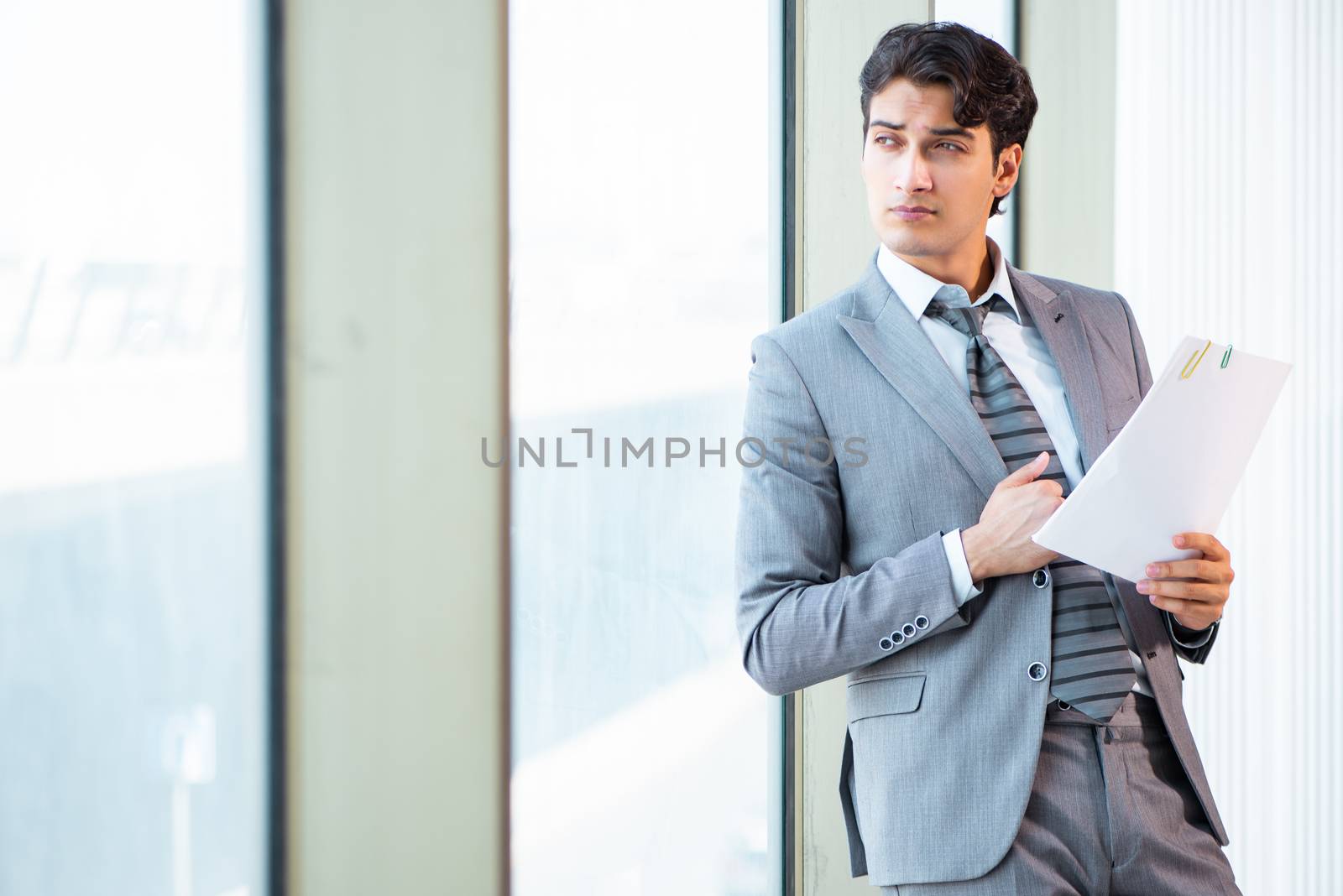 Young successful businessman working at the office 