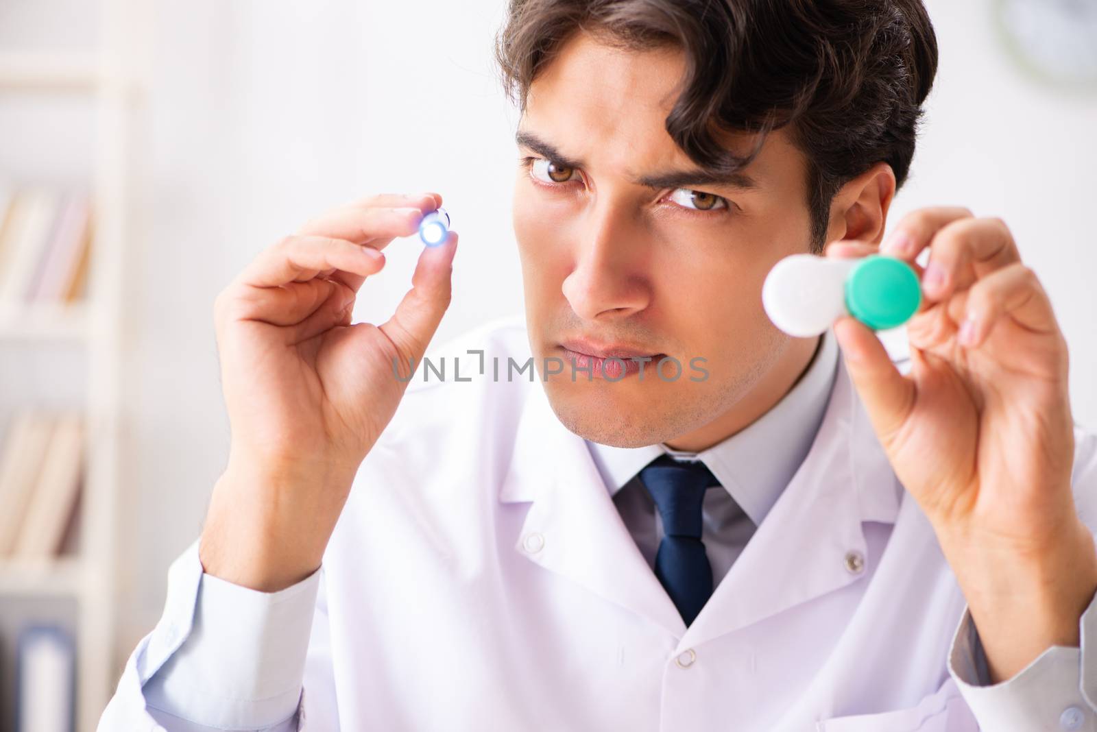 Young handsome doctor oculist working at the clinic 