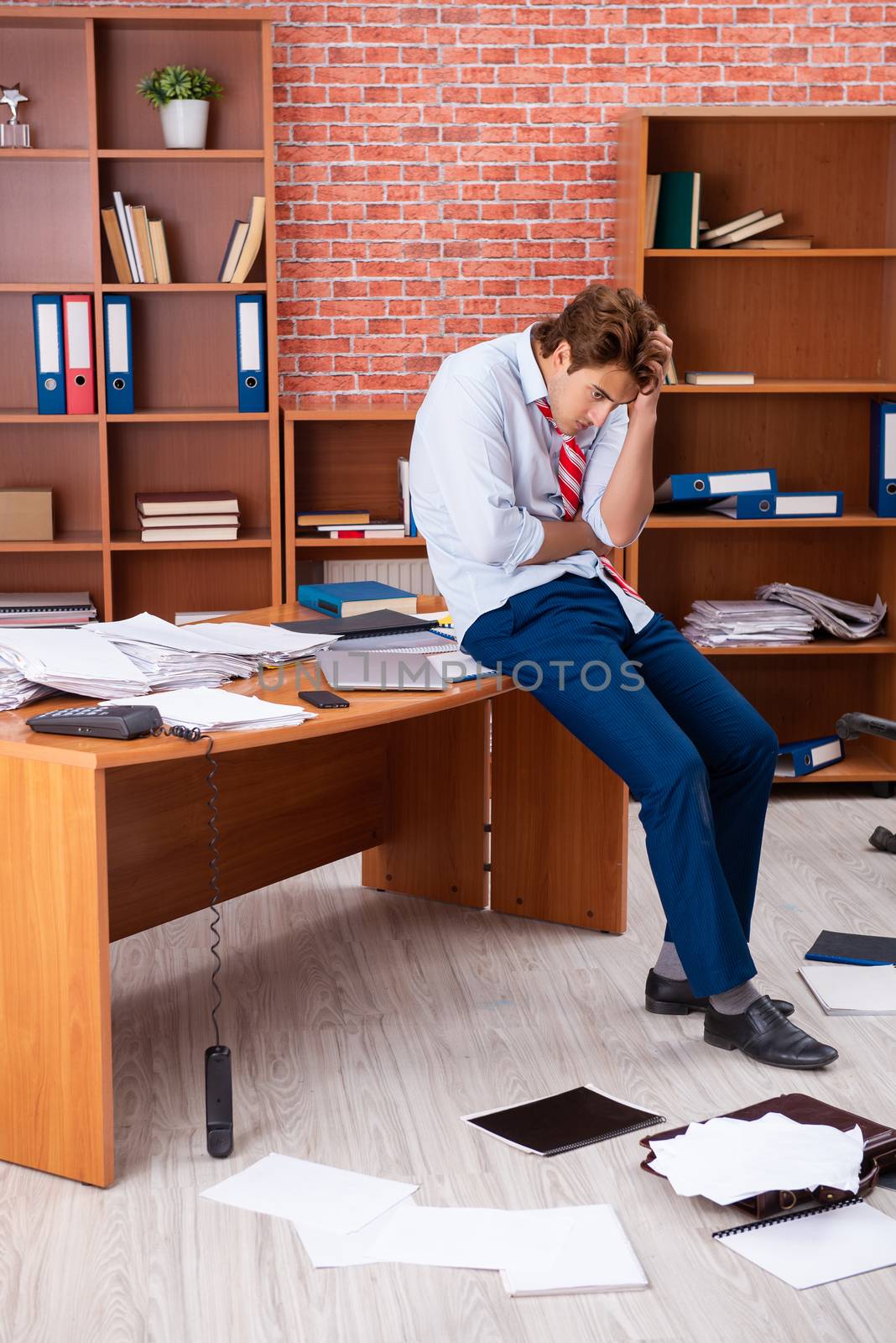 Unhappy businessman sitting in the office 