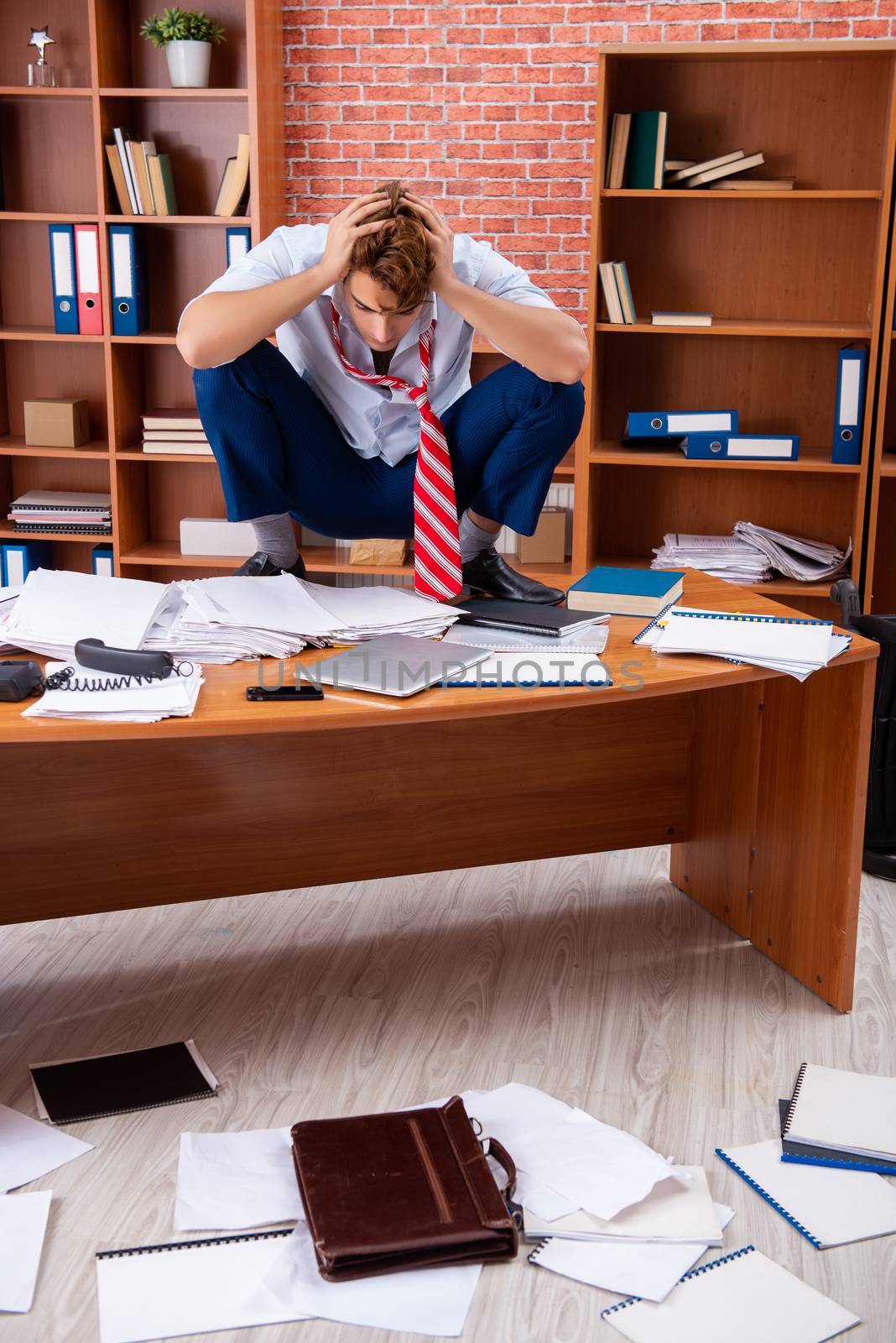 Unhappy businessman sitting in the office 