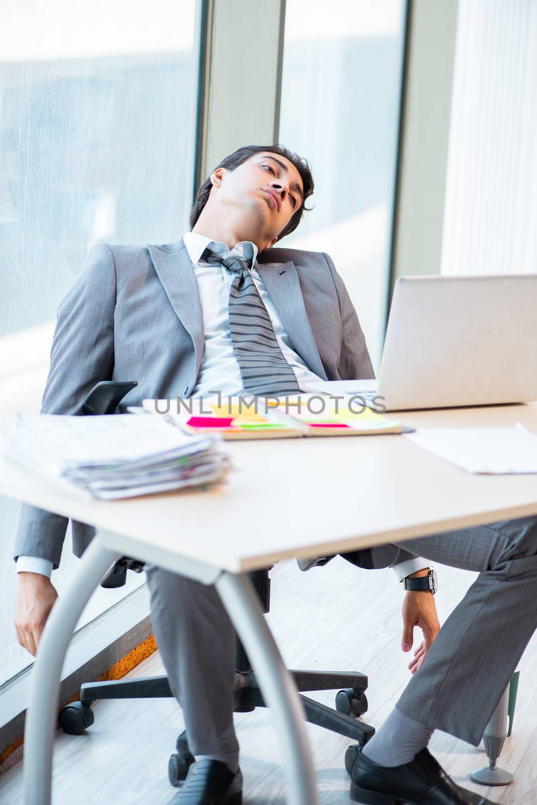 Young successful businessman working at the office 