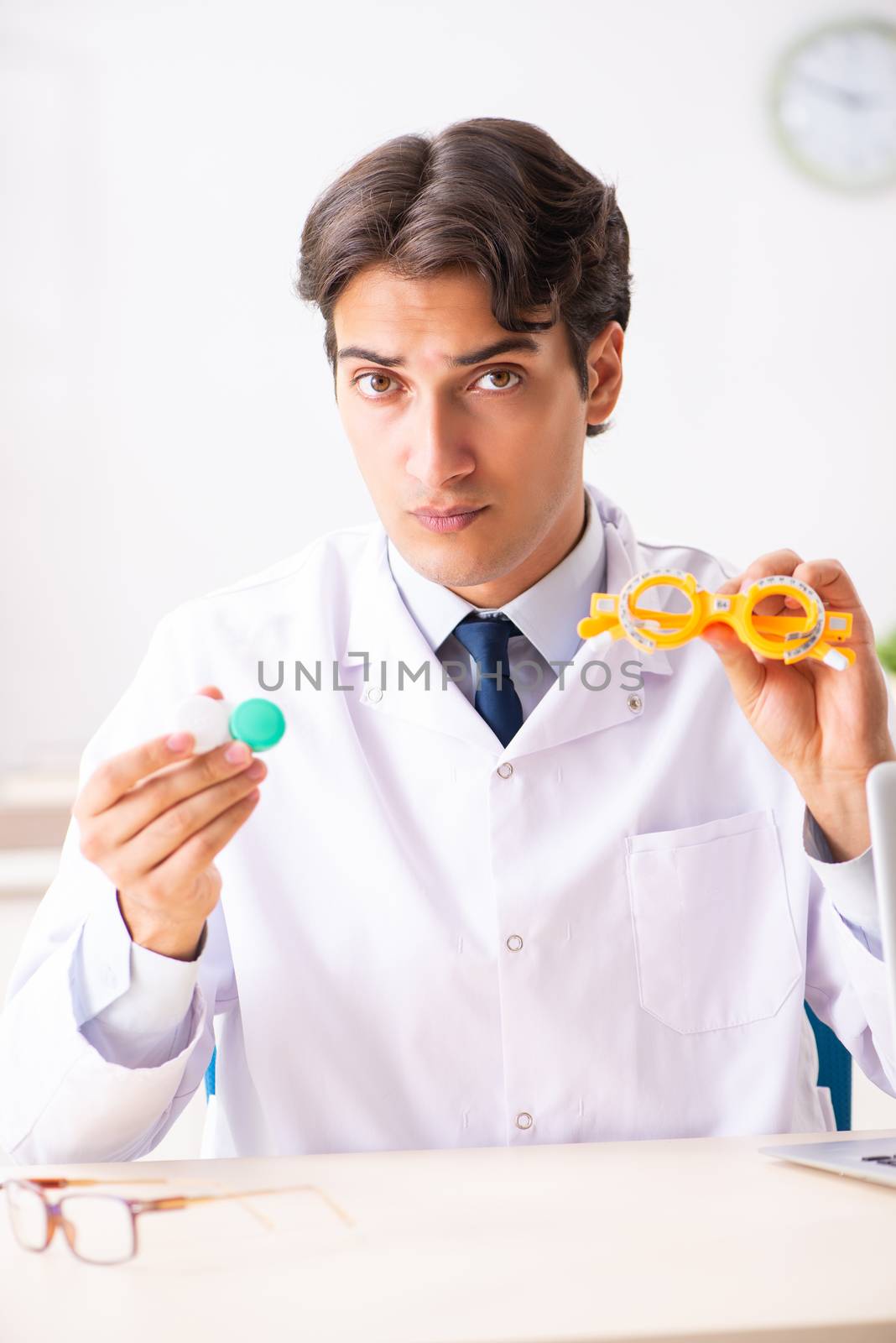 Young handsome doctor oculist working at the clinic 