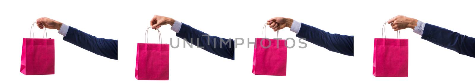 Hand holding shopping bags with christmas shopping on white back